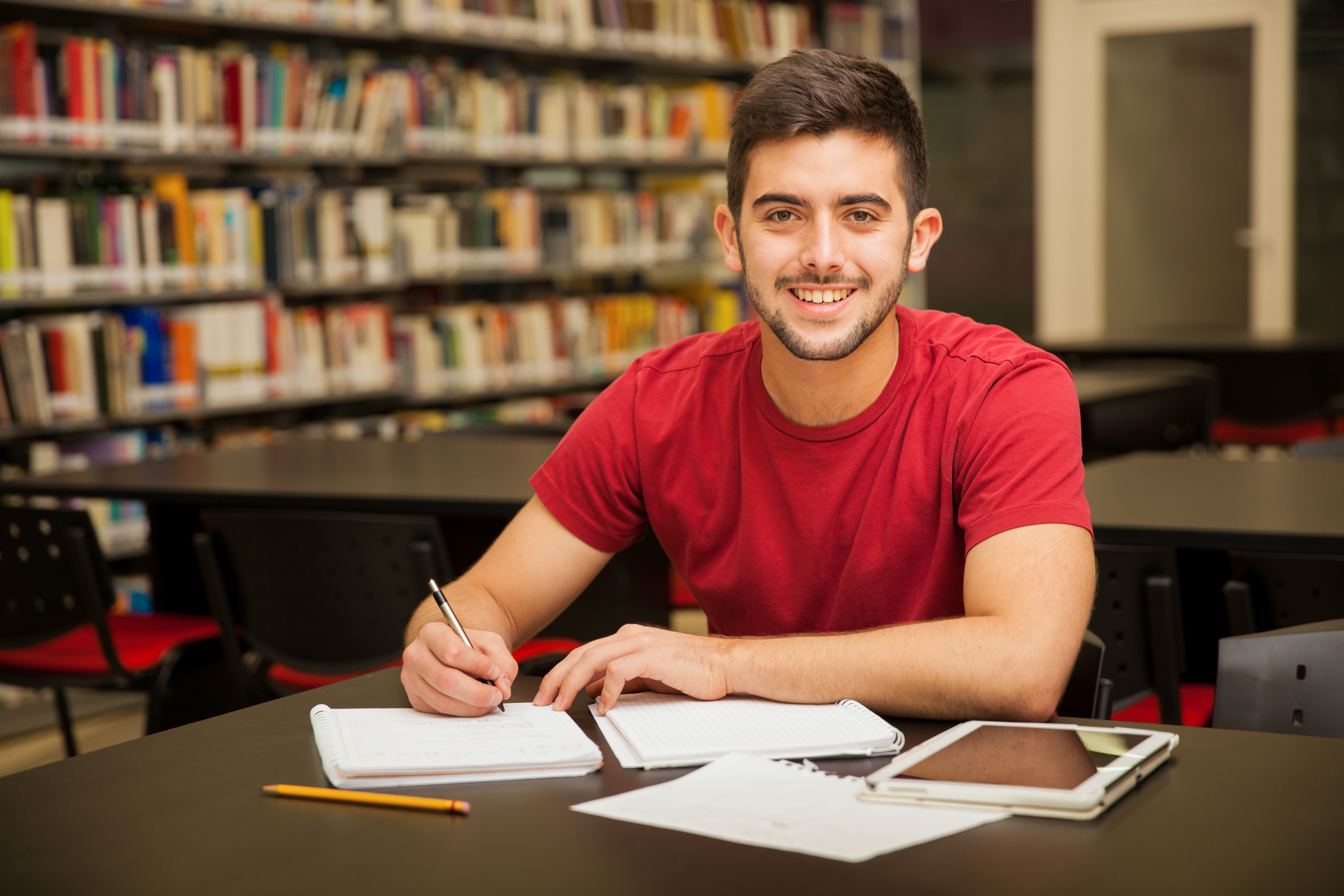 student doing homework in library